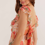 model wears floral pink and orange maxi dress