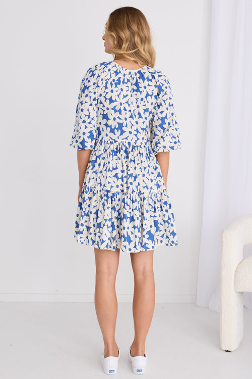 model wears a blue floral mini dress
