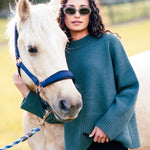 model wears a green knit jumper