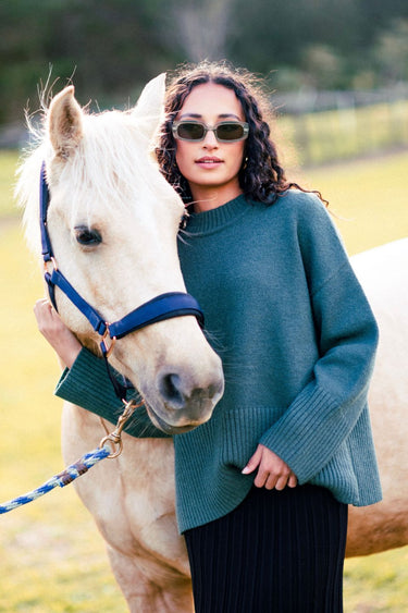 model wears a green knit jumper