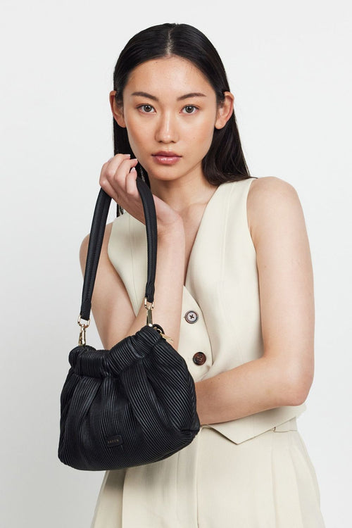 model wears a Black Shoulder Bag