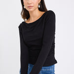 model wears a black long sleeve top with blue jeans
@col_pattern