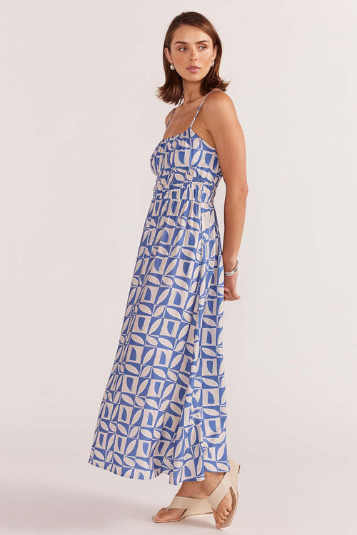 model wears a blue white print maxi dress