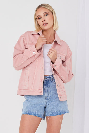 model wears pink denim jacket 