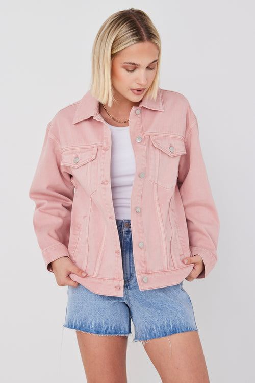 model wears pink denim jacket 