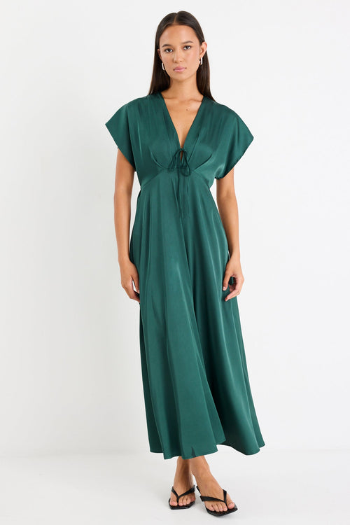 Woman wearing a green dress on a white background