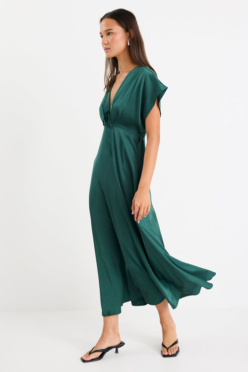 Woman wearing a green dress on a white background