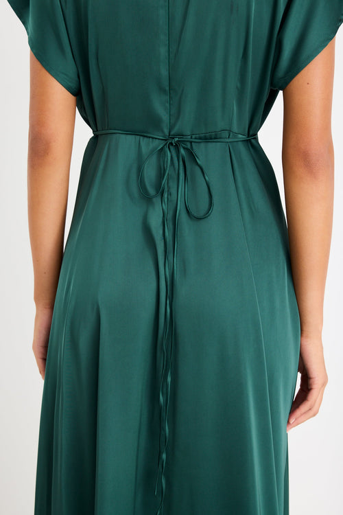 Woman wearing a satin green maxi dress