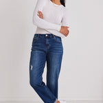 Model wears blue jeans with a white top 