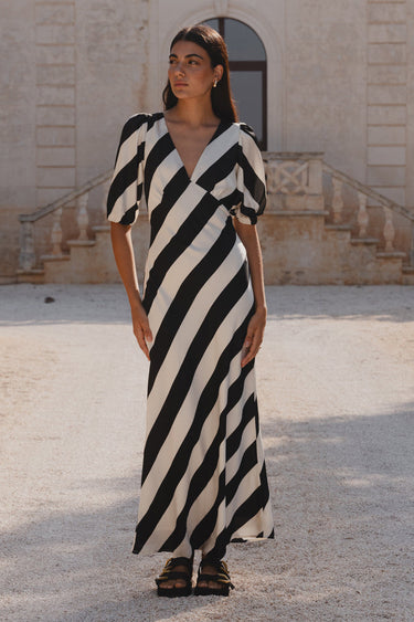 model wears black and white stripe dress