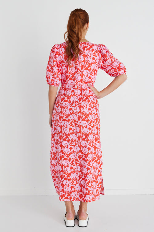 Model wears a pink floral midi dress