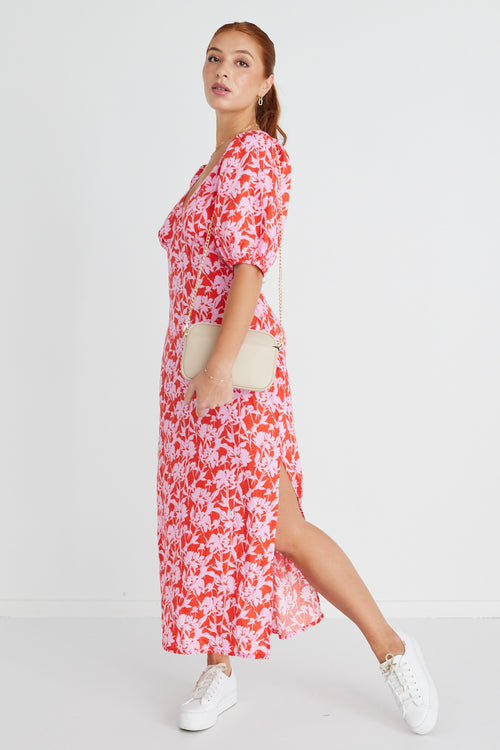 Model wears a pink floral midi dress