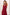 A woman modeling a sleeveless halter-neck maxi dress in deep burgundy with a wrap-style V-neck and a tie detail at the waist, set against a plain light beige studio background.