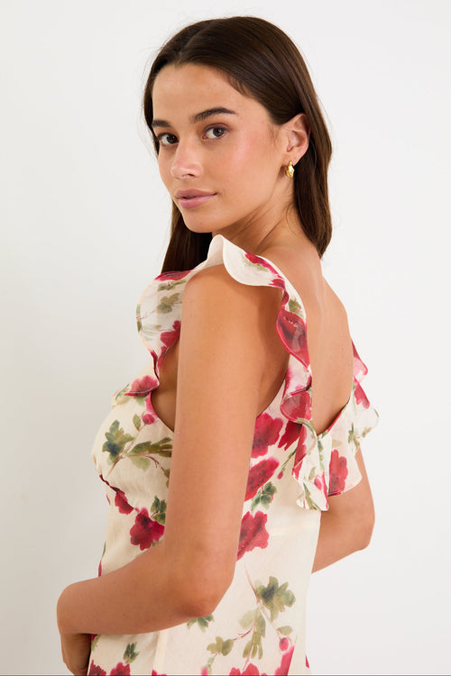 Woman wearing a floral white dress with frills
