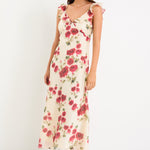 Woman wearing a floral white dress with frills