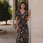 model wears a black beige patten maxi dress