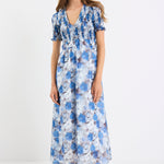 Woman wearing a blue floral dress on a white background