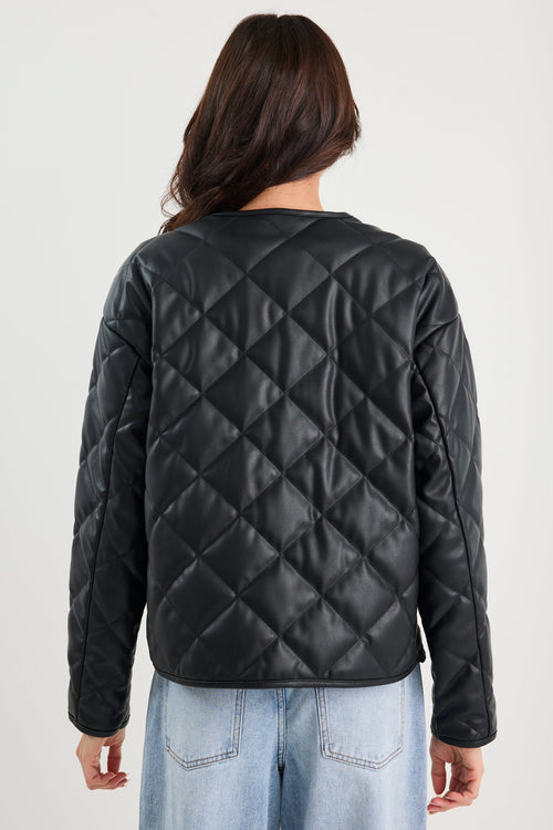 Woman wearing a black quilted jacket