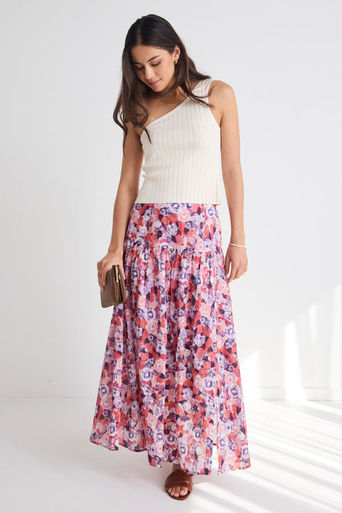 model wears a pink floral skirt