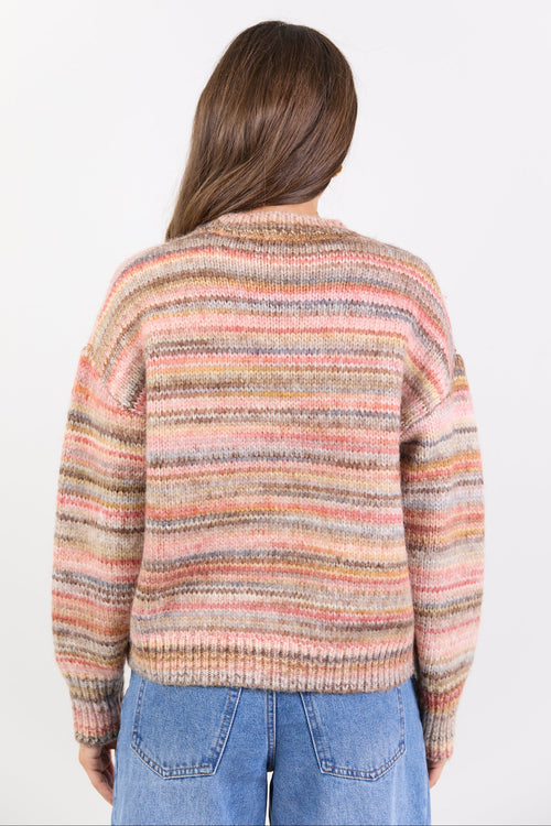 Person wearing a multicolored striped sweater on a white background