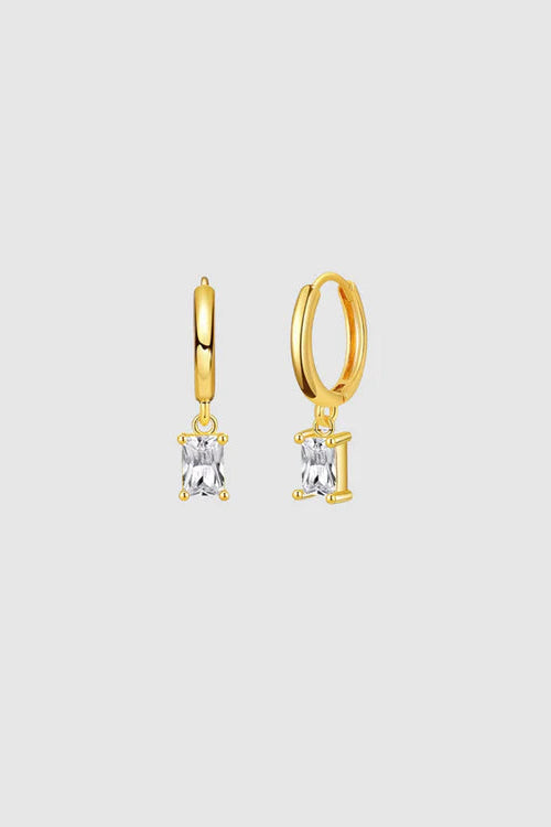 Gold hoop earrings with clear gemstones on a light gray background