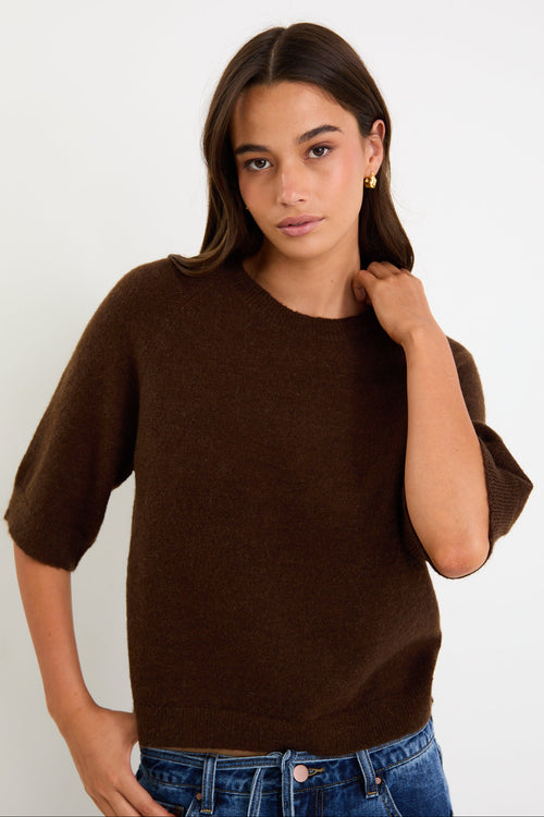 Woman wears a chocolate knit tee