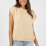 model wears a beige top