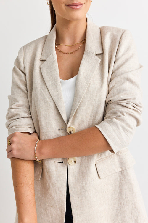 model wears a beige linen blazer