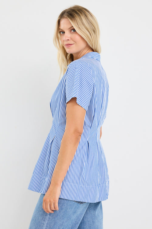 model wears a blue stripe corset blouse with blue jeans
