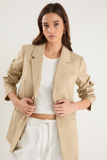 model wearing a beige blazer