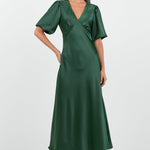 Woman wearing a green dress on a white background