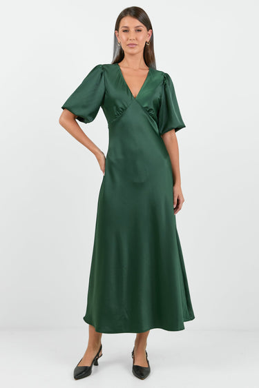 Woman wearing a green dress on a white background