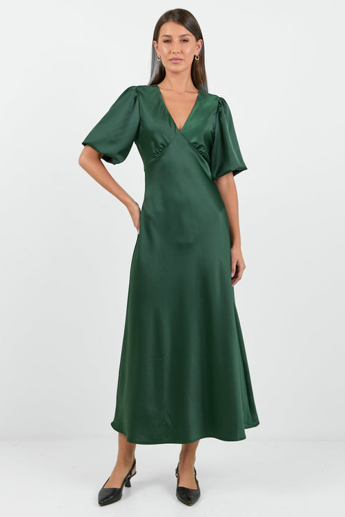 Woman wearing a green dress on a white background