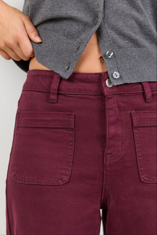 Maroon pants with a gray shirt on a white background