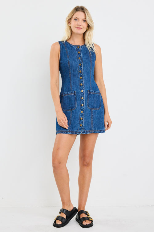 model wears a blue denim mini dress