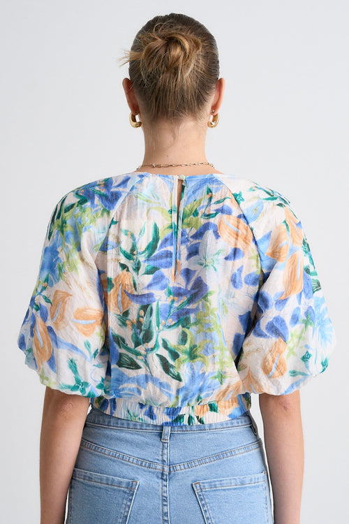 model wears a blue orange floral top