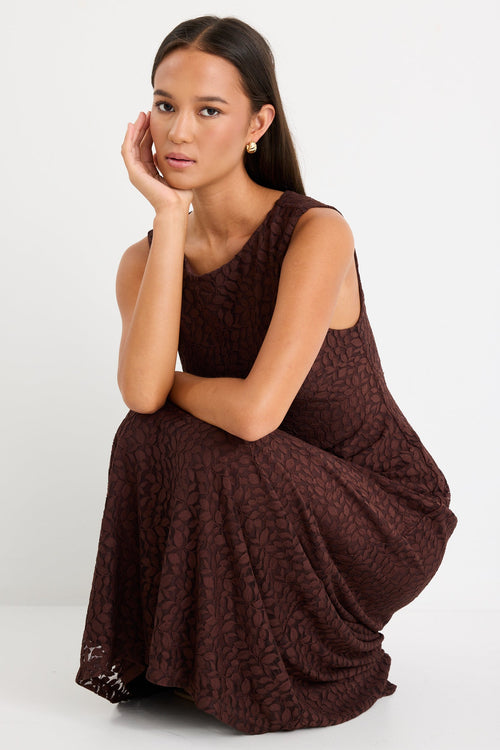 Woman wearing a brown lace maxi dress