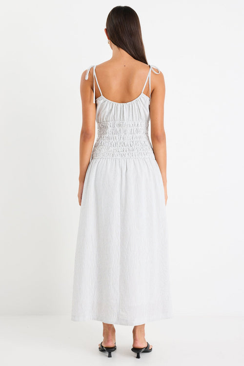 Woman wearing a black and white midi dress