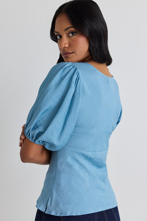 model wears a blue bias blouse