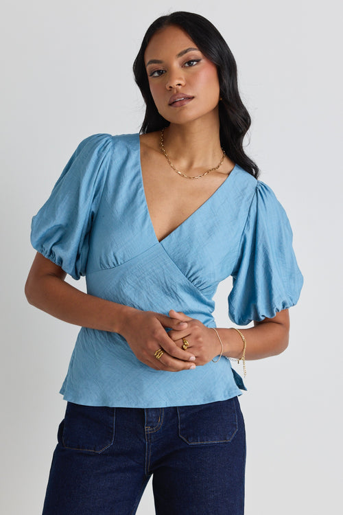 model wears a blue bias blouse