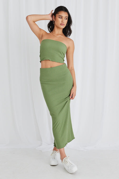 Model wearing green bandeau top and maxi skirt set