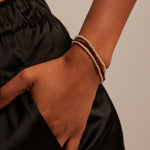 model wearing bronze beaded set of bracelets