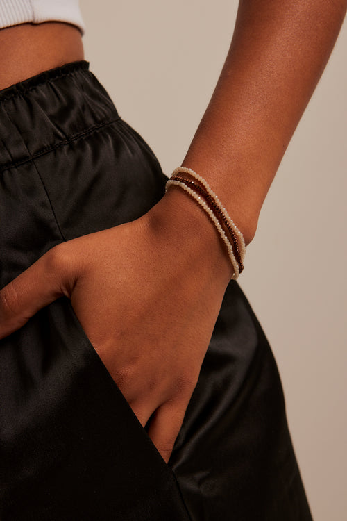 model wearing bronze beaded set of bracelets