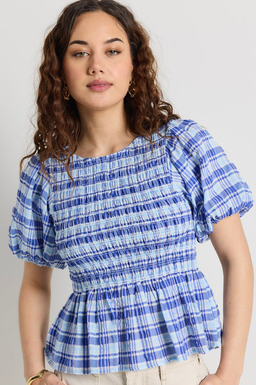 model wears a blue check frill top