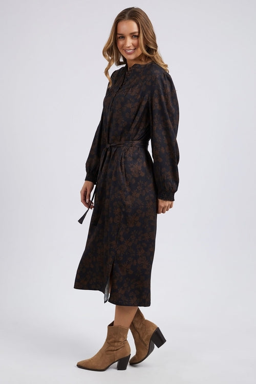 model wears a brown floral long sleeve midi dress