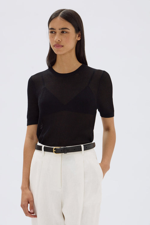 model wears a black tee