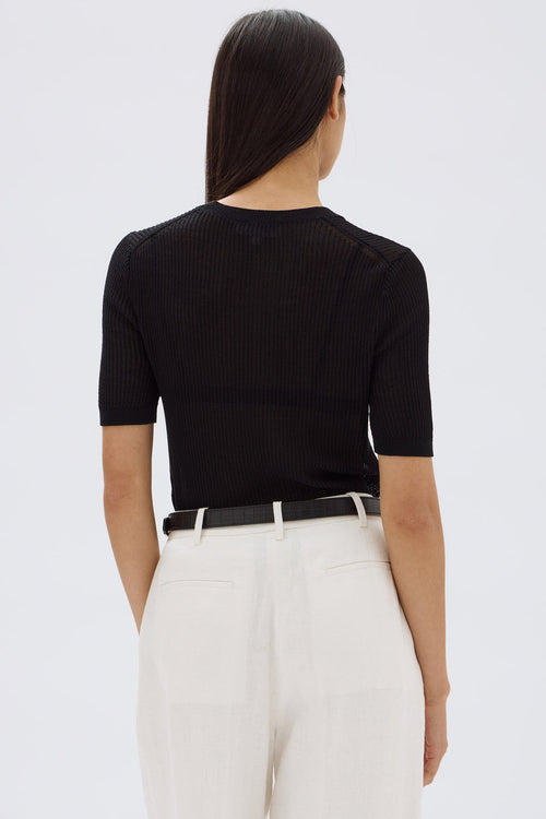 model wears a black tee