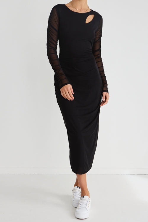 model wears a black long sleeve dress