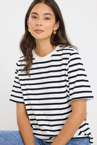 model wears a black and white stripe tee