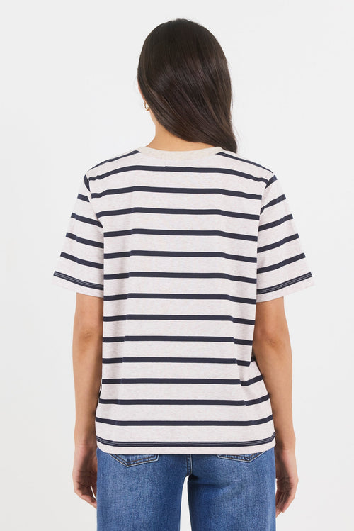 Person wearing a black and white striped t-shirt and blue jeans on a white background